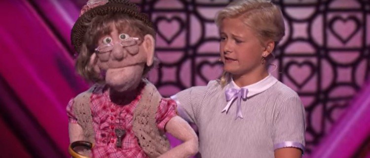 Image of girl ventriloquist and puppet.