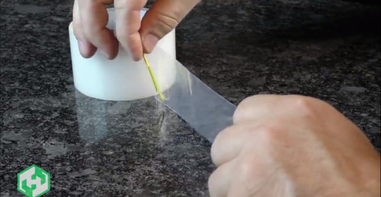 Image of paper clip on roll of tape.