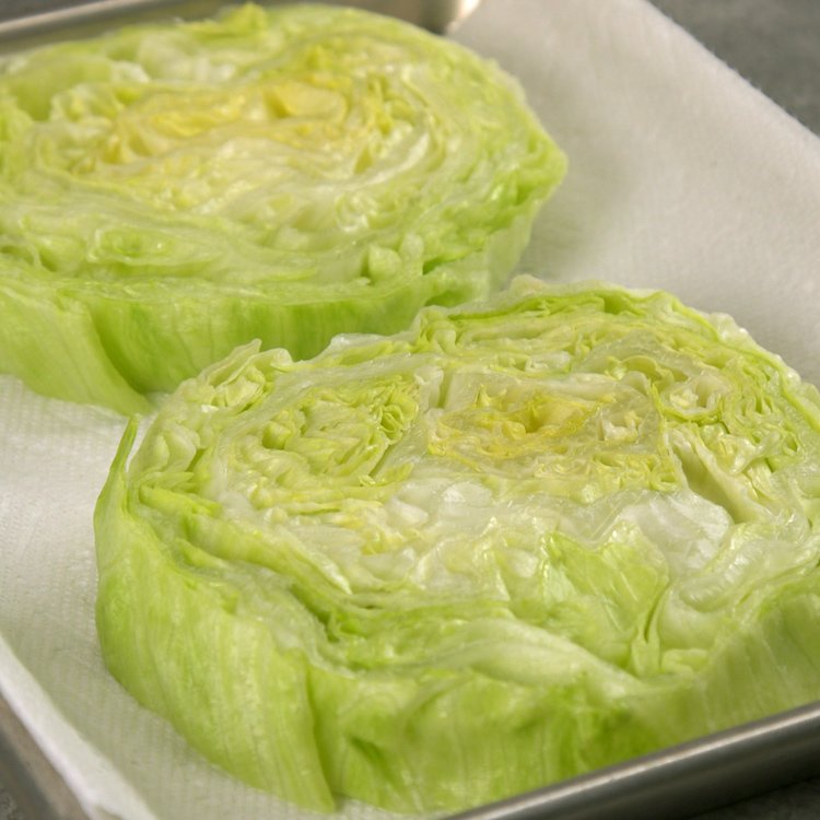 Chilled, crisp iceberg lettuce covered in creamy blue cheese dressing, bacon, croutons, & tomatoes--plus one new twist that makes this the ultimate wedge salad.