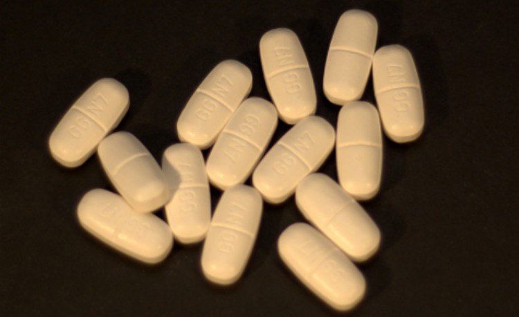 orange pills against a black background