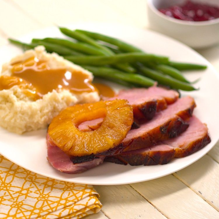 Old Fashioned Baked Ham with Pineapple & Maple Brown Sugar Glaze plated mashed potatoes gravy green beans