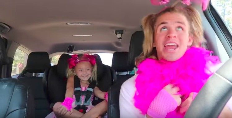 Cole and Everleigh in pink outfits in car