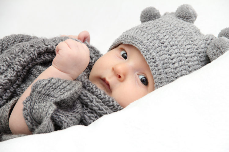 Image of Beautiful baby in gray knitted hat
