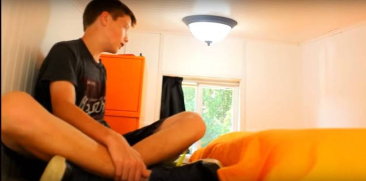 Image of kid in tiny house loft.