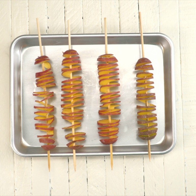 Place tornado skewered potatoes on baking dish