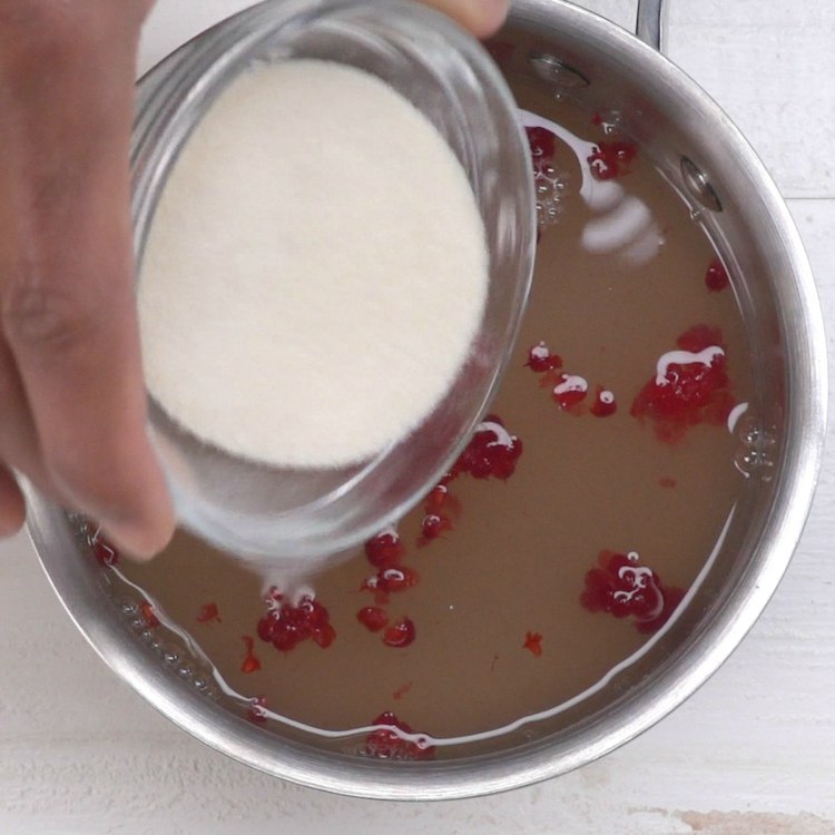 In a small saucepan, combine lemon juice, raspberries, sugar and water