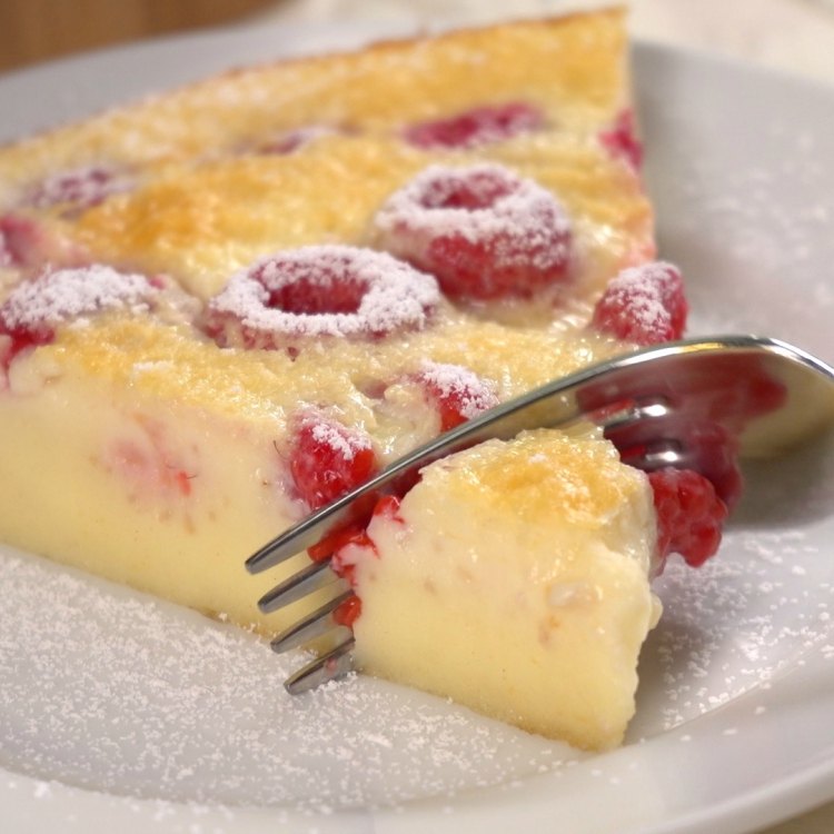 Fork going into piece of raspberry clafoutis to eat