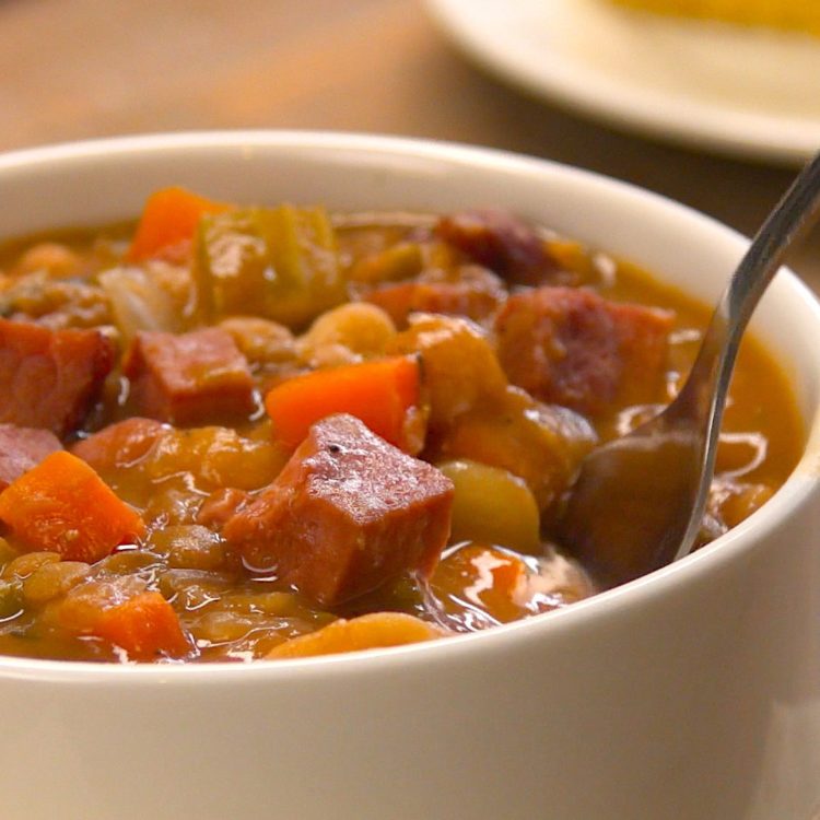 Slow Cooker Ham & Bean Soup close-up spoon taking a bite