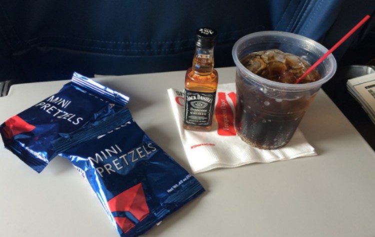 mixed drink and pretzels on plane