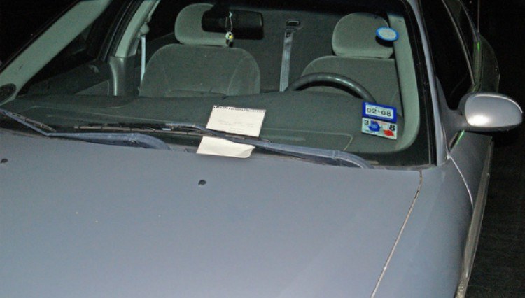 silver car with note on windshield