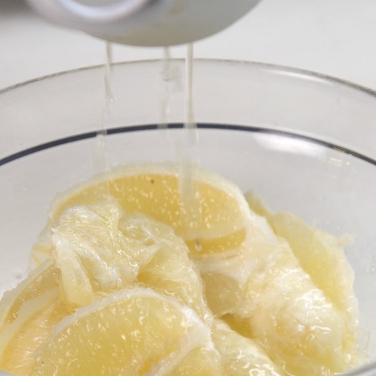 Scoop lemon flesh, seeds, and any remaining membrane out with a spoon and into a bowl