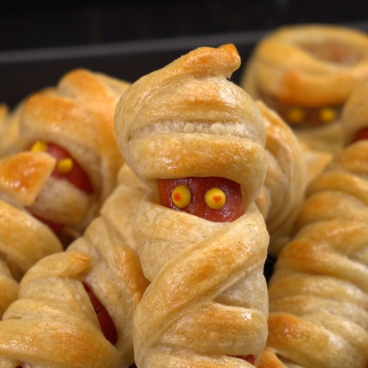 Hot dogs wrapped in dough and baked to look like mummies