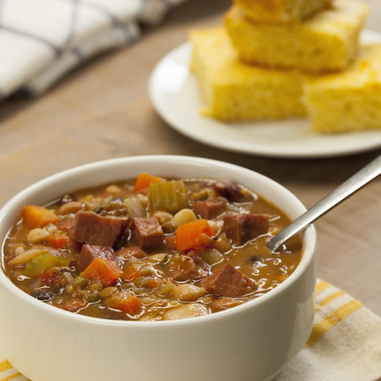 Slow Cooker Ham & Bean Soup bowl spoon in cornbread