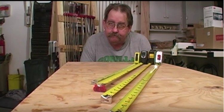 Tom Hintz poses with several tape measurers