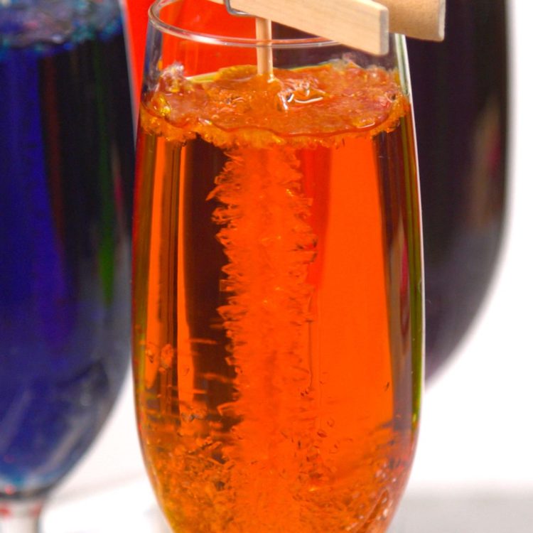 Homemade Rock Candy crystals growing in orange glass