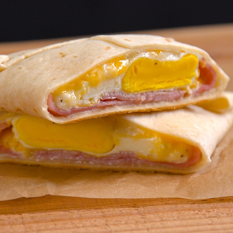 Easy, portable breakfast pockets stuffed with ham, gooey melted cheese, and a perfectly-done baked egg. The best part is, there's absolutely zero clean-up.