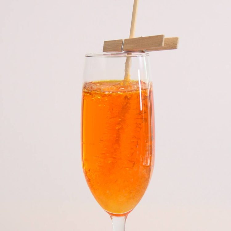 Homemade Rock Candy orange glass with pin close-up