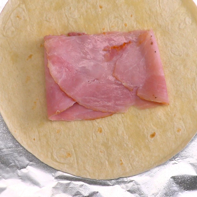 Easy, portable breakfast pockets stuffed with ham, gooey melted cheese, and a perfectly-done baked egg. The best part is, there's absolutely zero clean-up.