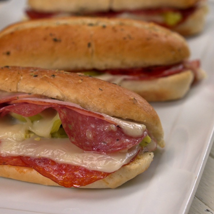 Baked sandwiches with Italian meats and garlic herb butter