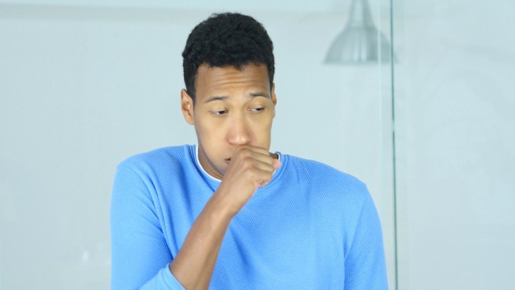 Image of male coughing.
