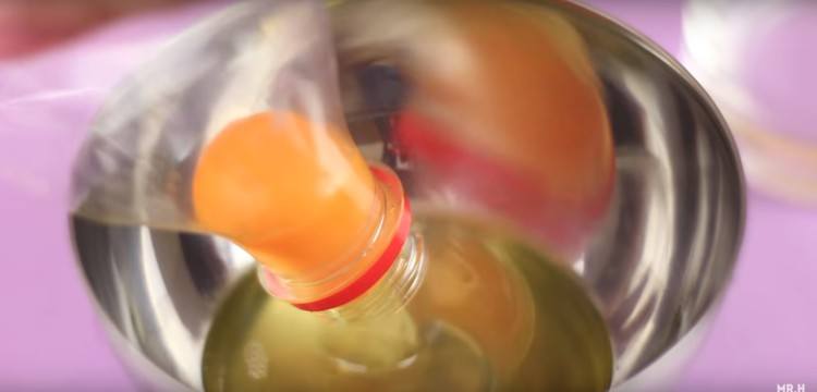 Using a bottle to remove yolks.