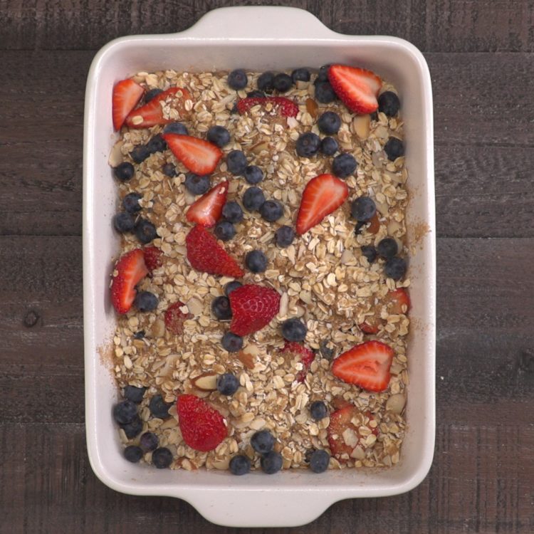 Heartwarming breakfast bake spiced with brown sugar and cinnamon, and filled with creamy rolled oats, toasted almonds, and juicy strawberries & blueberries.