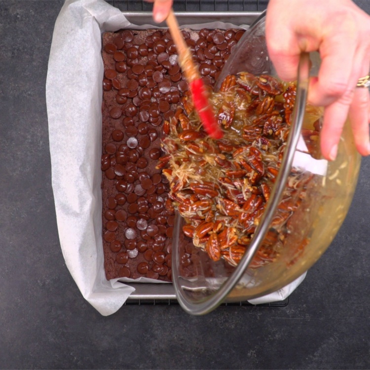 Pouring pecan topping on German chocolate crust base
