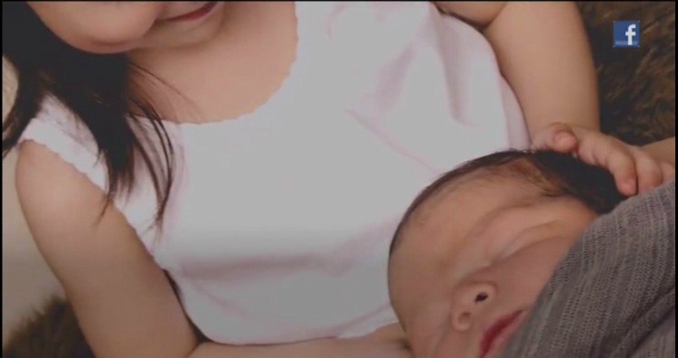Image of big sister and baby boy.
