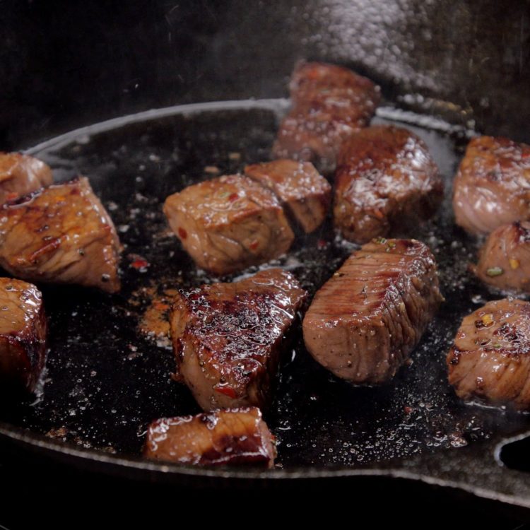 Honey Balsamic Steak Bites sizzling in the pan