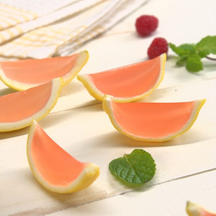 Homemade pink lemonade Jell-O shots in lemon wedges