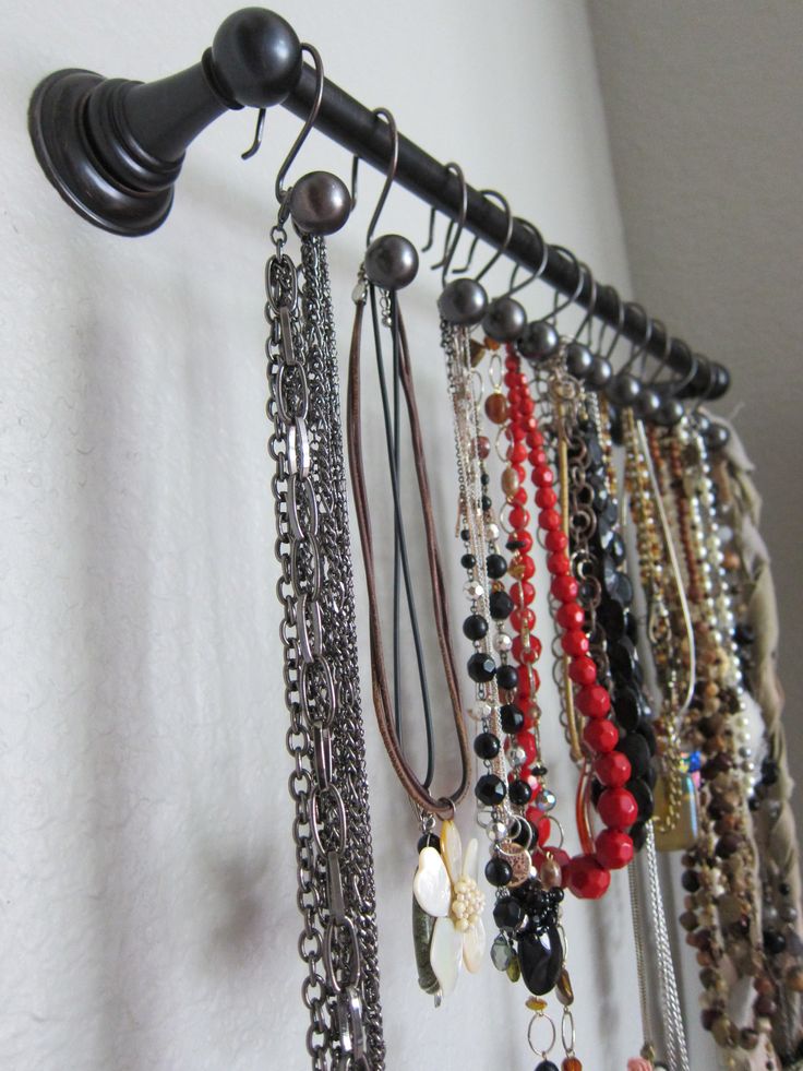 Using towel bars to organize jewelry.