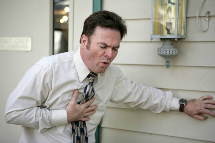 Image of man holding chest.