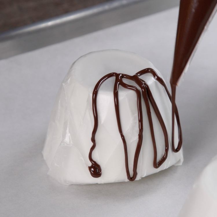 Squeeze chocolate over the lined bowls in a loopy,overlapping pattern