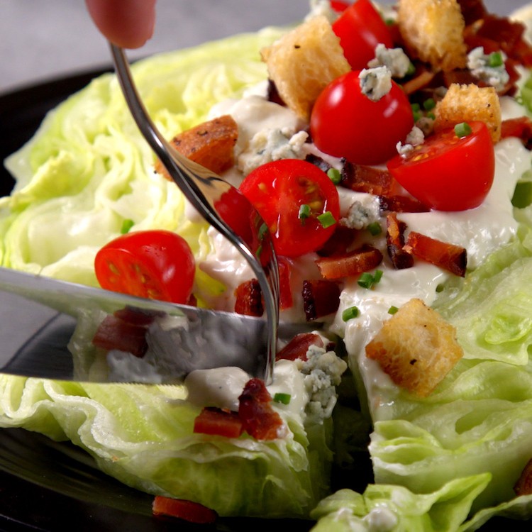 Chilled, crisp iceberg lettuce covered in creamy blue cheese dressing, bacon, croutons, & tomatoes--plus one new twist that makes this the ultimate wedge salad.
