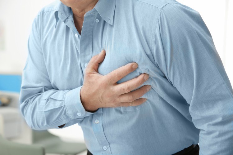 Image of man clutching heart.