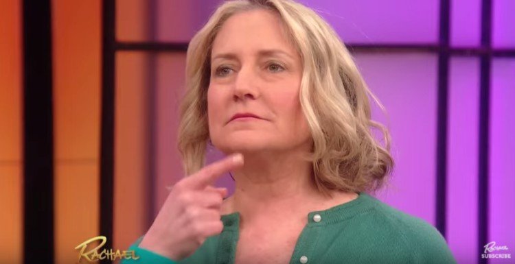 Finger on woman's chin.