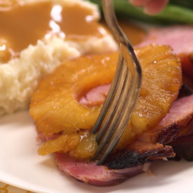 Old Fashioned Baked Ham with Pineapple & Maple Brown Sugar Glaze taking a bite
