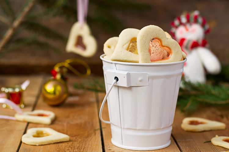 Image of stained glass cookies on Christmas decoration background