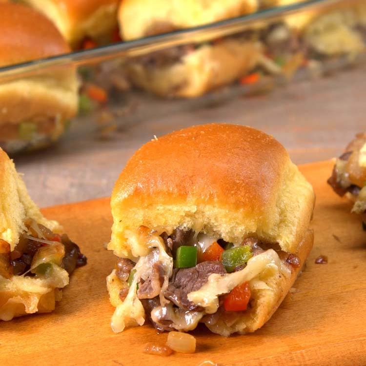 Philly Cheesesteak Sliders close-up with cheese, onions, peppers, and steak