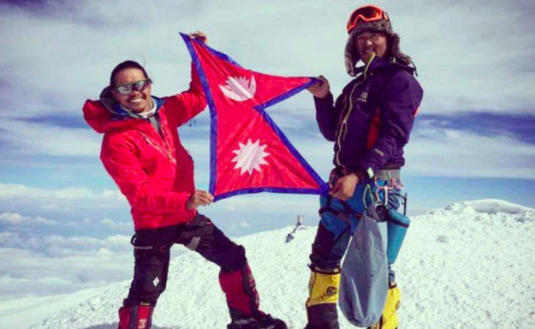 men stand holding Nepalese flag