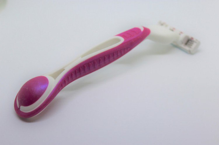 pink razor on white background