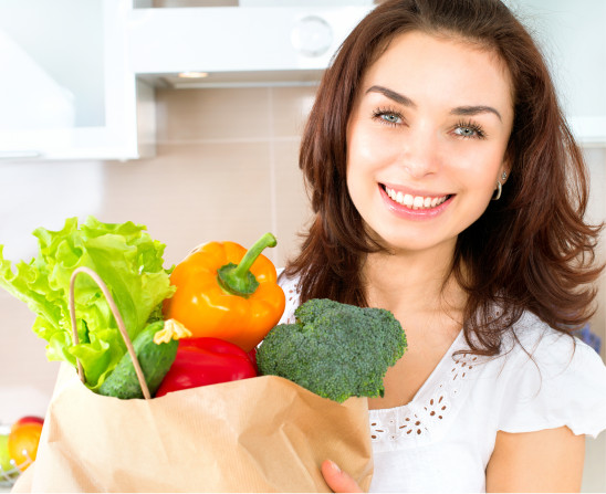 Happy Young Woman with Vegetables in Shopping Bag. Diet Concept