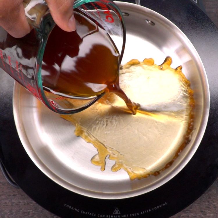 Baked BBQ Ribs sauce pouring into pot bigger splash