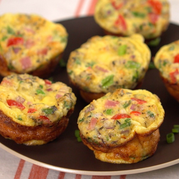 Plate of grab and go omelettes baked with tomato, cheese and onion