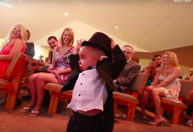 Image of ring bearer taking hat off