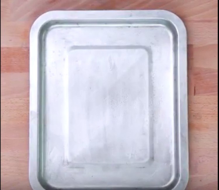 clean silver pan on wood background