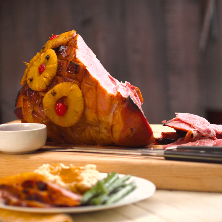 Old Fashioned Baked Ham with Pineapple & Maple Brown Sugar Glaze plated focus on ham