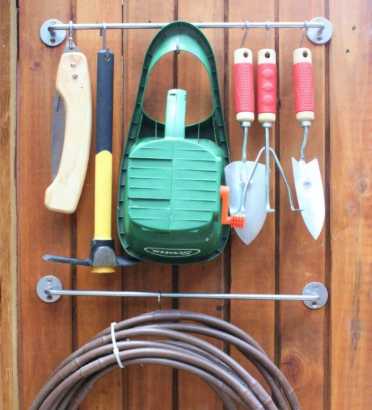 Gardening tools hung on towel bar.
