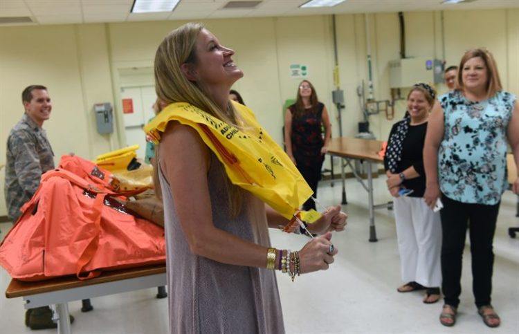 Woman wearing airplane life vest.