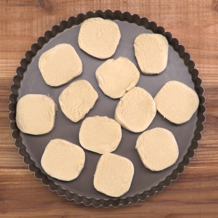 sugar cookie fruit tart dough pieces in pan